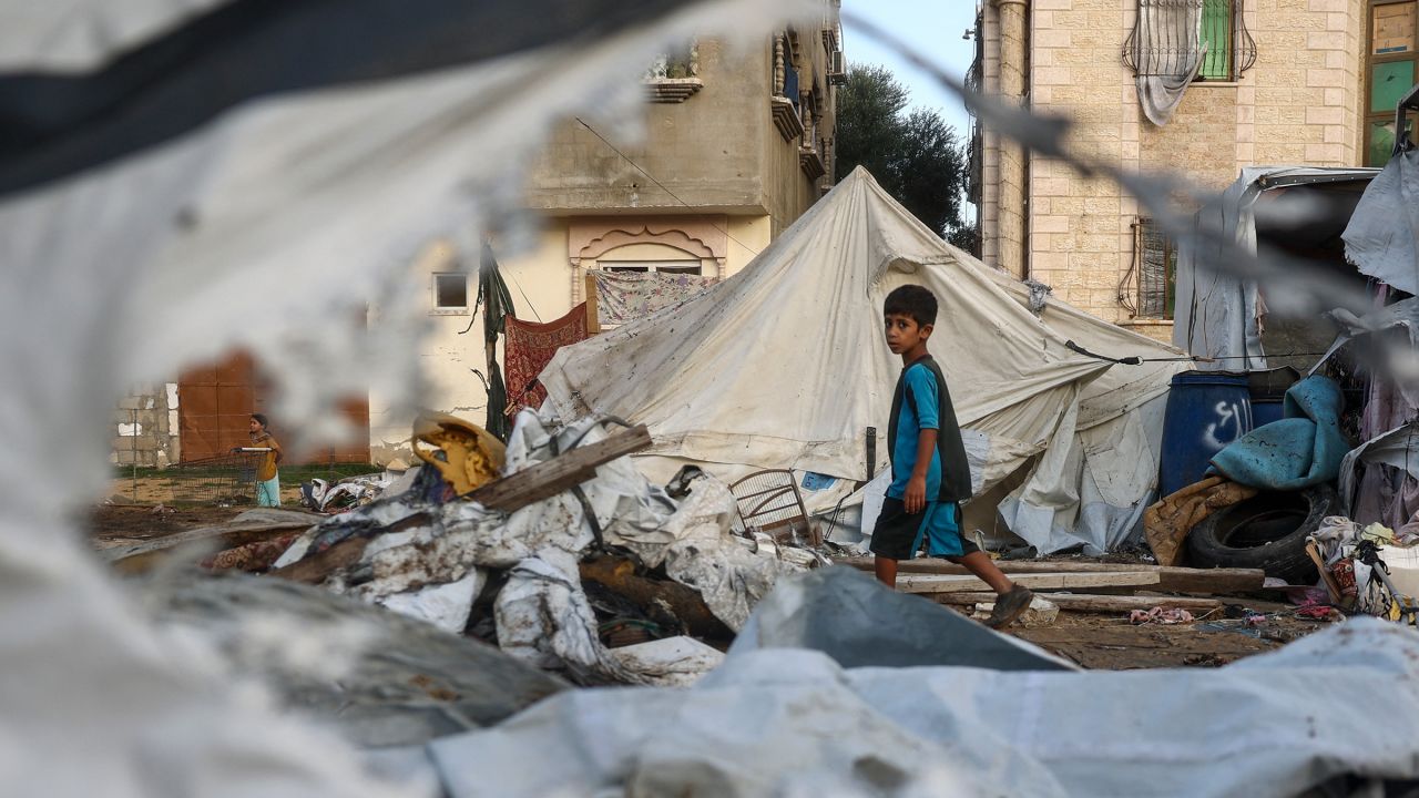 A child walks next to destroyed tents following an Israeli air strike the previous night on the Bureij refugee camp in the central Gaza Strip on October 8.