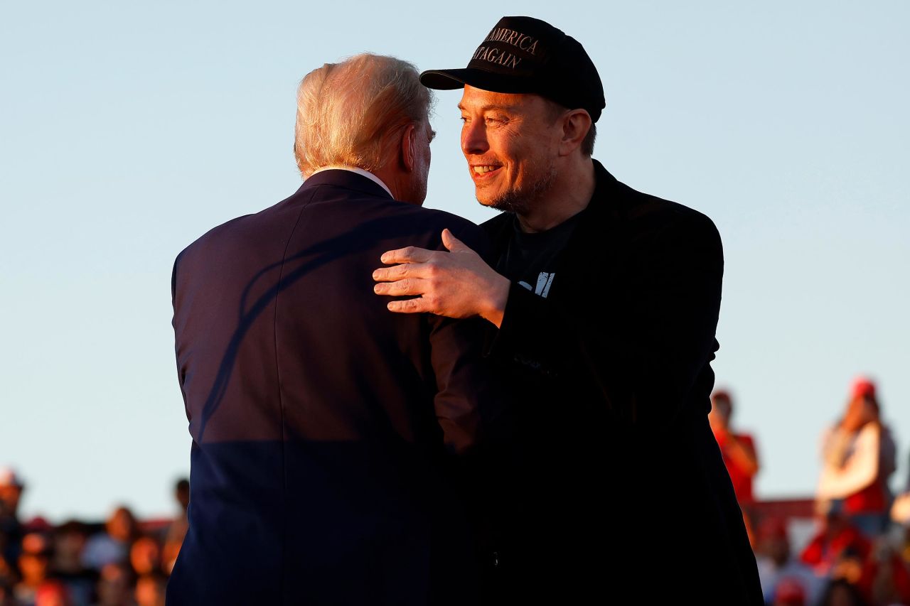 Elon Musk embraces former President Donald Trump during a campaign rally at the Butler Farm Show fairgrounds on October 5 in Butler, Pennsylvania.