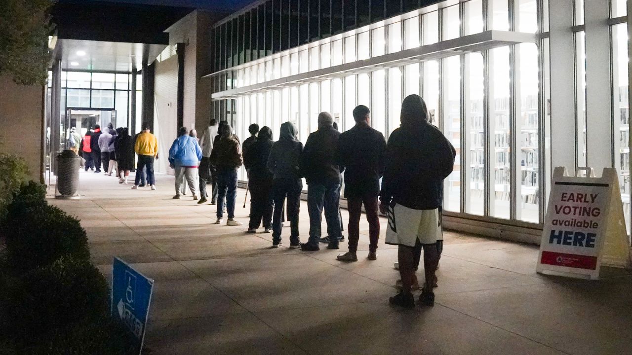 People stand in line at Metropolitan Library to cast their votes in the US presidential election on October 15 in Atlanta.