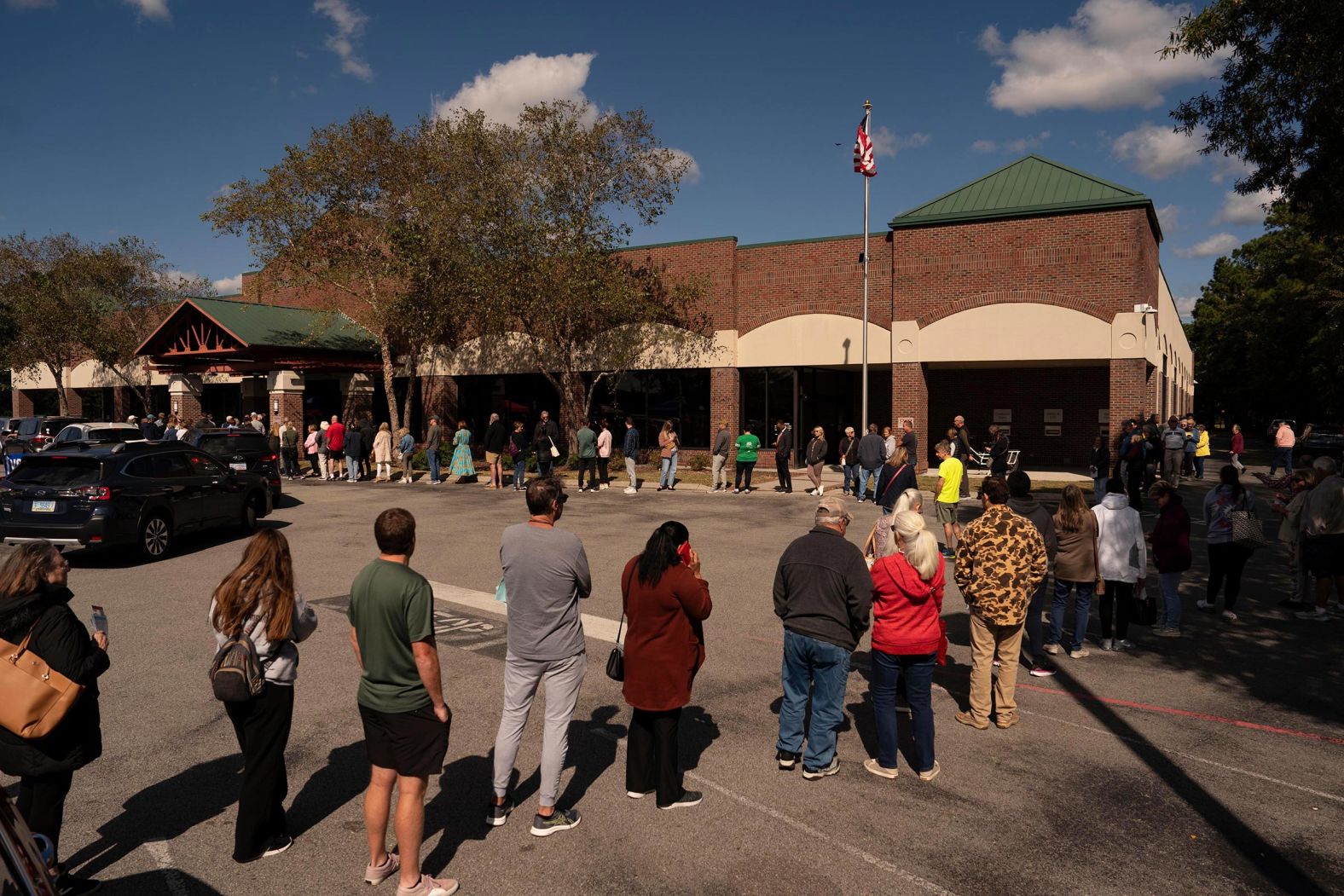 Voters wait in line during the first day of early voting at a polling station in Wilmington, North Carolina, on October 17. 