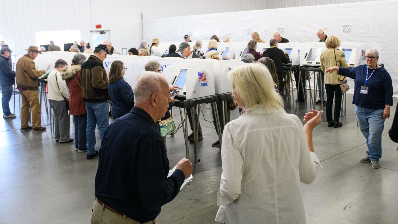 Poll workers help voters inside an early voting site on October 17 in Hendersonville, North Carolina.