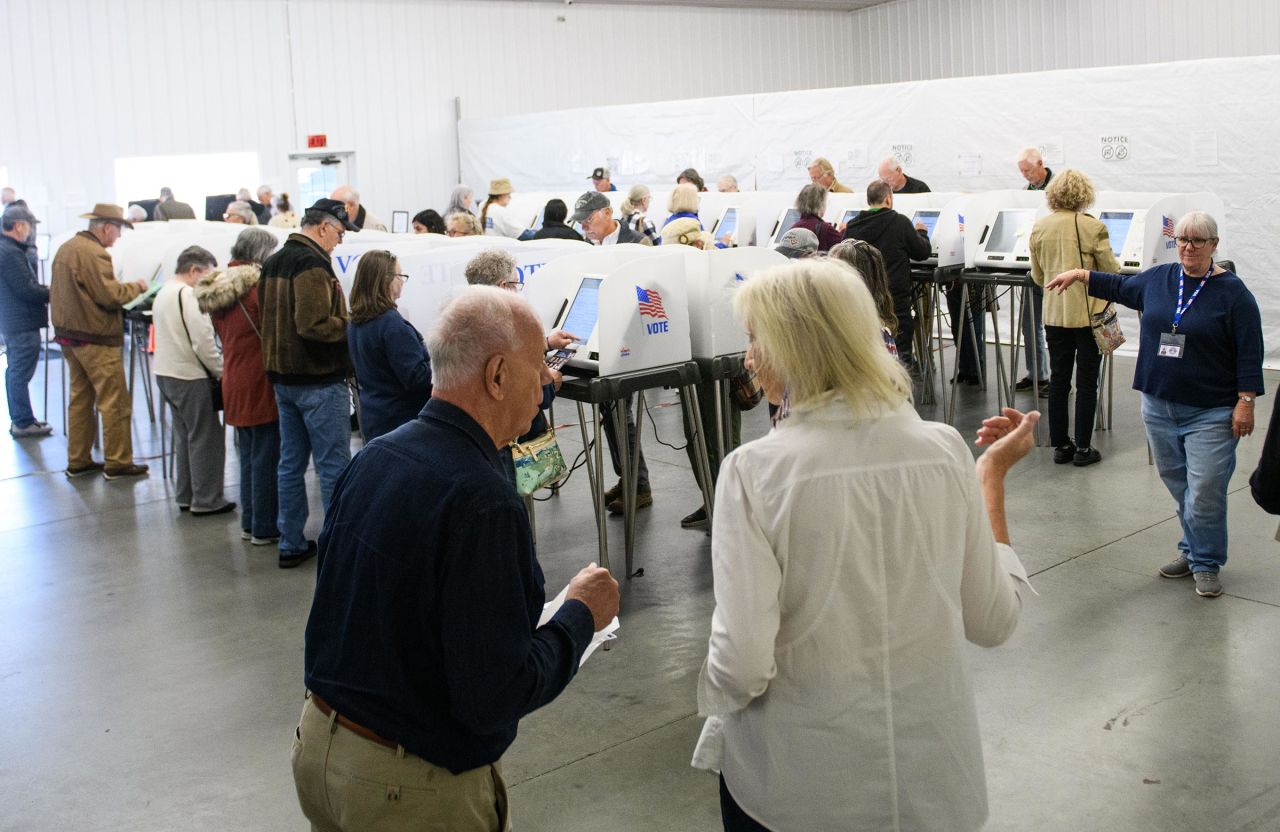 Poll workers help voters inside an early voting site on October 17 in Hendersonville, North Carolina.