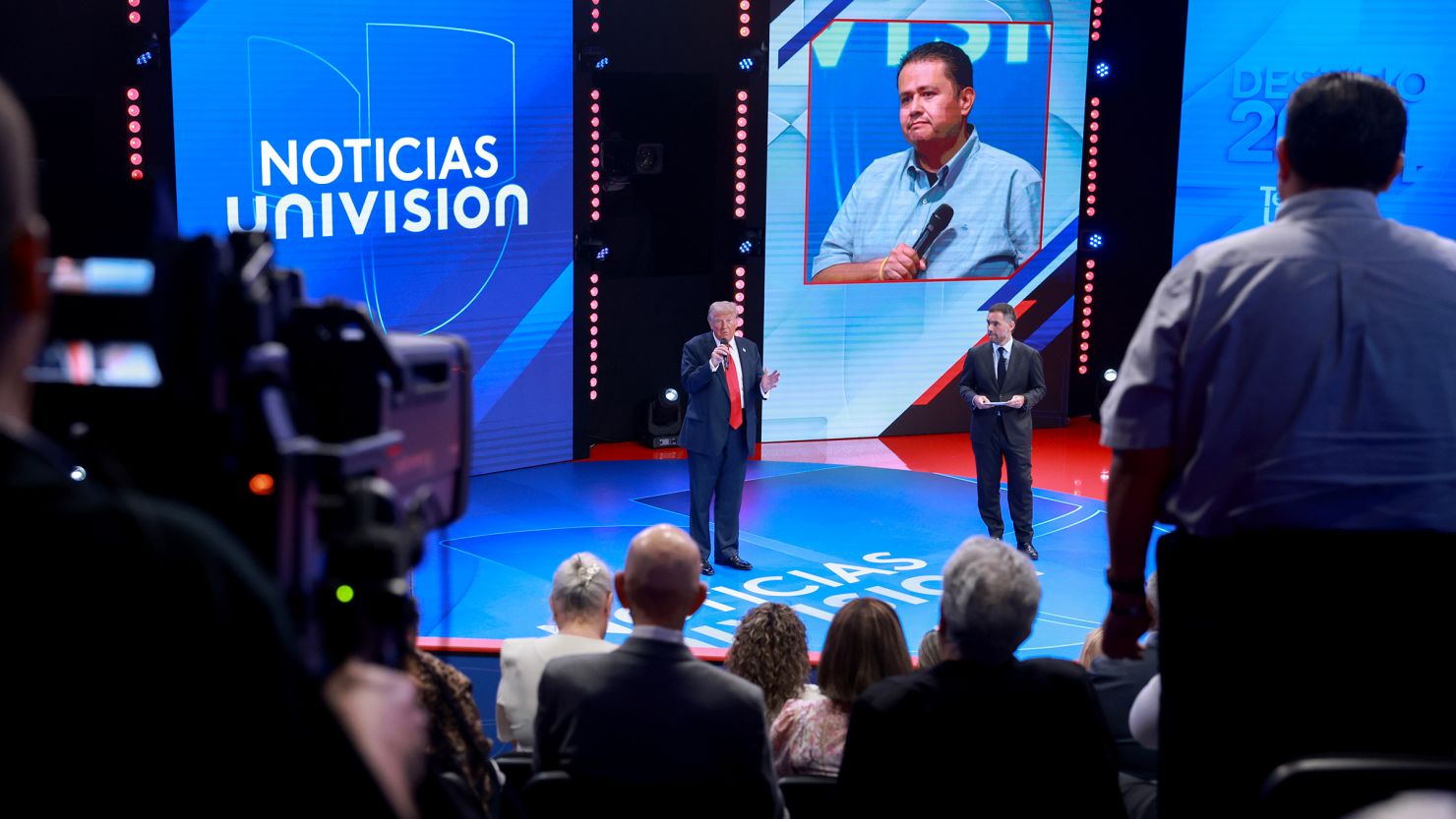 Former President Donald Trump answers a question as moderator Enrique Acevedo looks on during a Univision Noticias town hall event on October 16, 2024 in Doral, Florida.