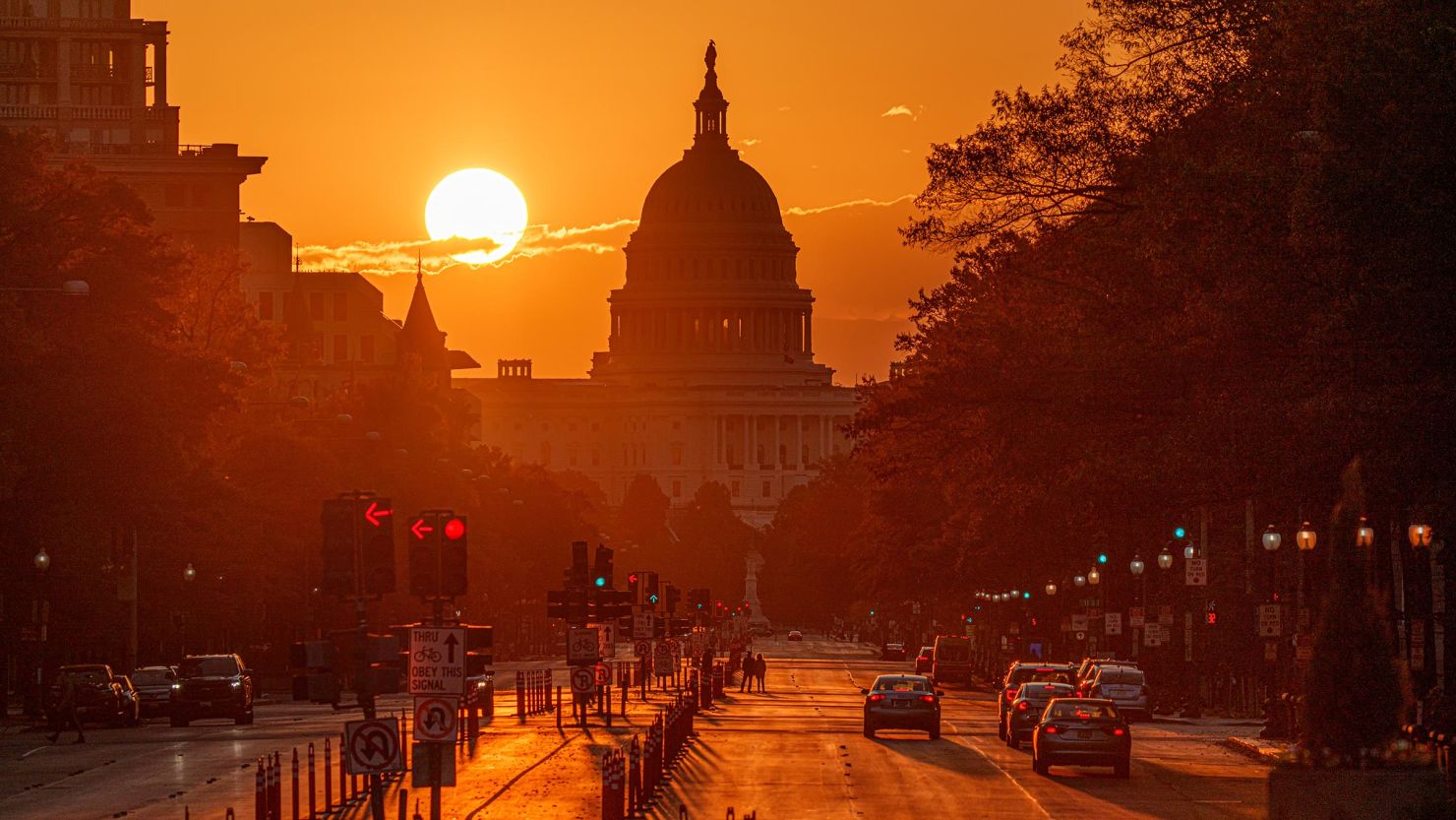 The sun rises behind the US Capitol building on October 26, in Washington, DC. 