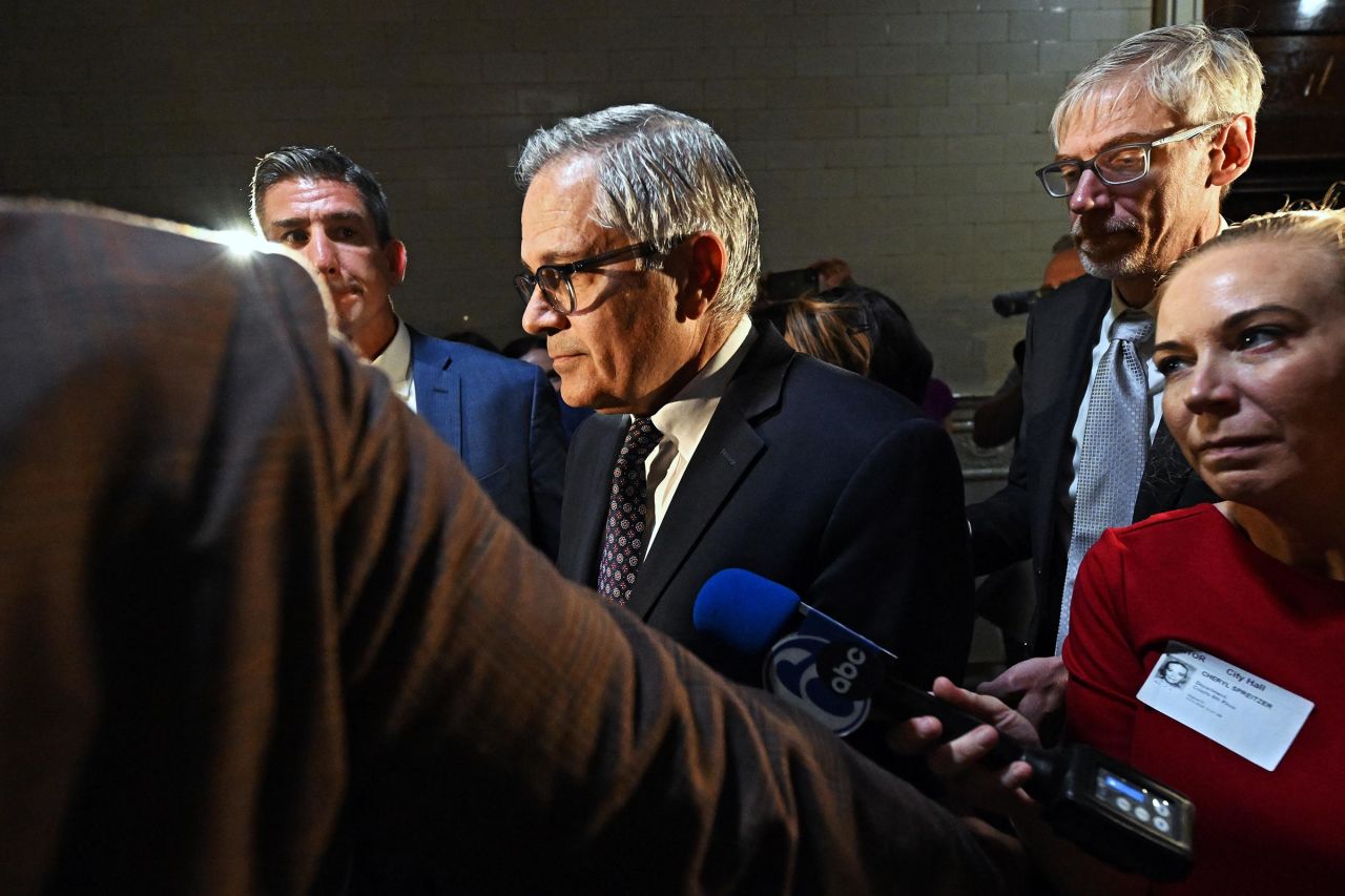 Philadelphia district attorney Larry Krasner, center, walks from the courtroom at city hall after a hearing over a lawsuit he filed against Elon Musk and his $1M giveaway petition contest on October 31 in Philadelphia.