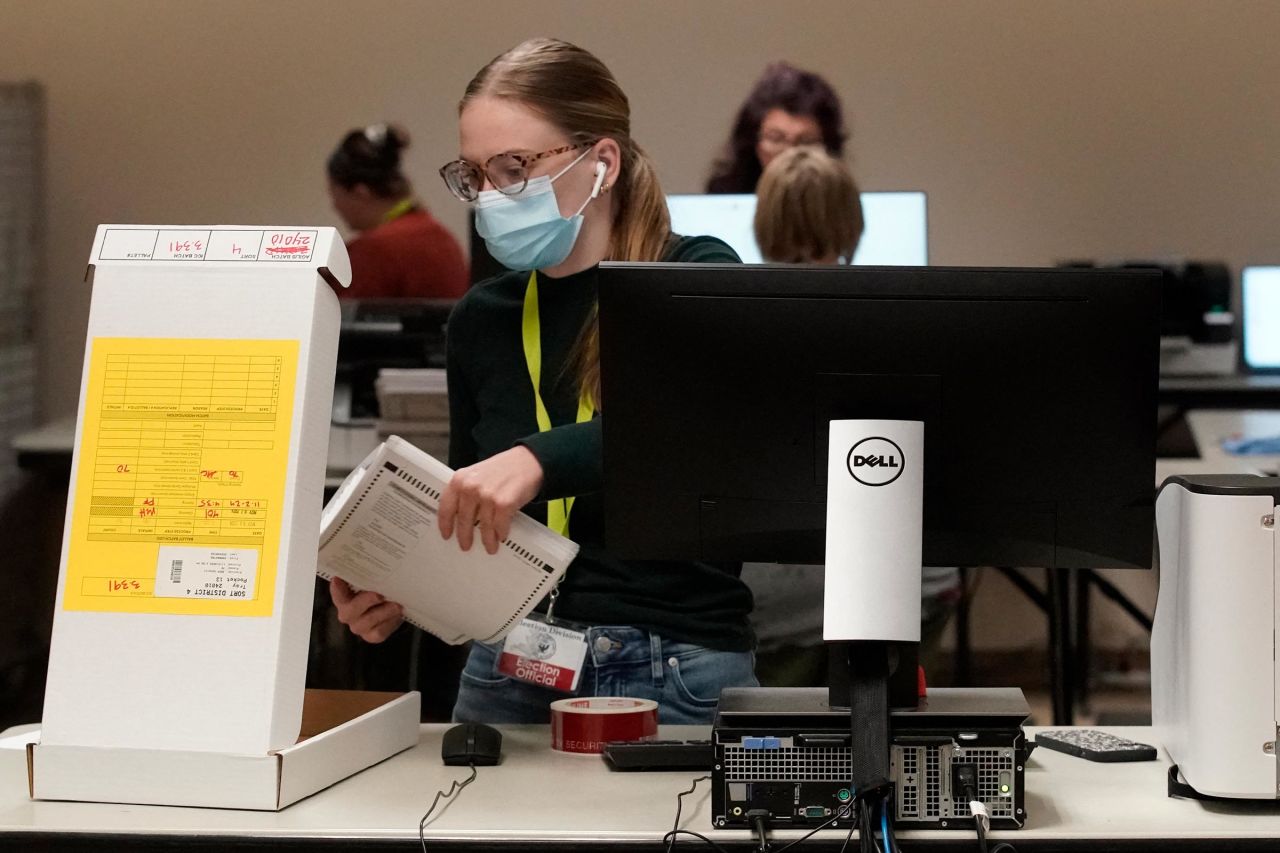 An election worker removes mail-in ballots from a counting machine at the Salt Lake County election offices in Salt Lake City, Utah, on November 4.