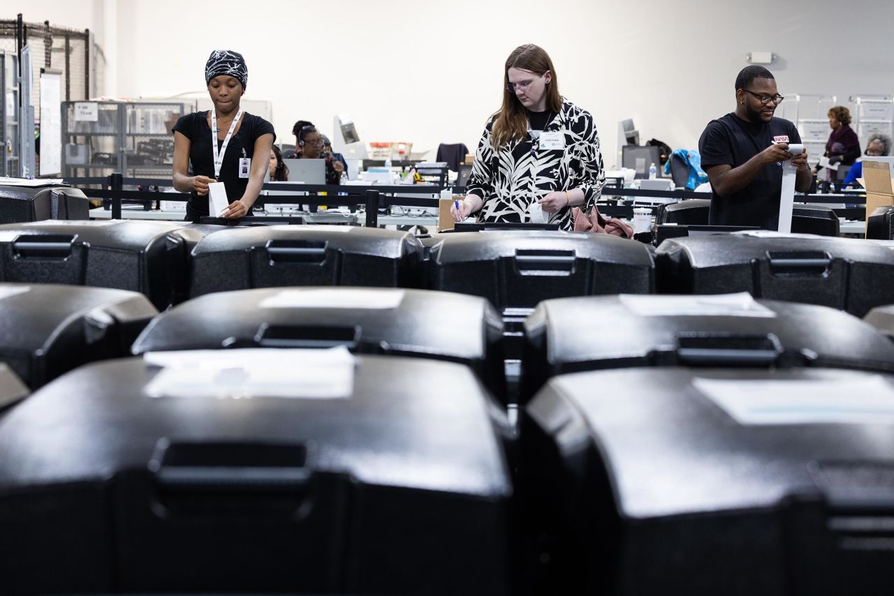 Gwinnett County election workers organize and prepare early in-person voting machines for final vote tabulation at the Gwinnett Voter Registrations and Elections on November 5 in Lawrenceville, Georgia.