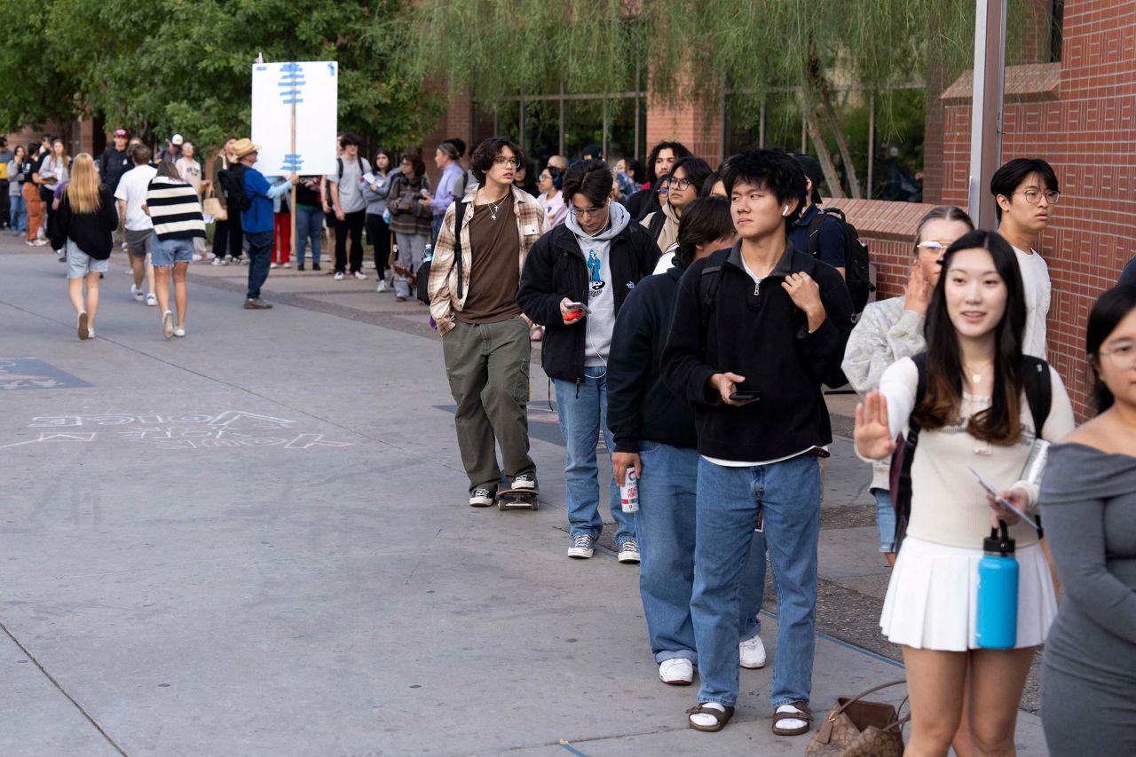 Voters wait in line at the Arizona State University polling location on Election Day in Tempe, Arizona, on Tuesday. 