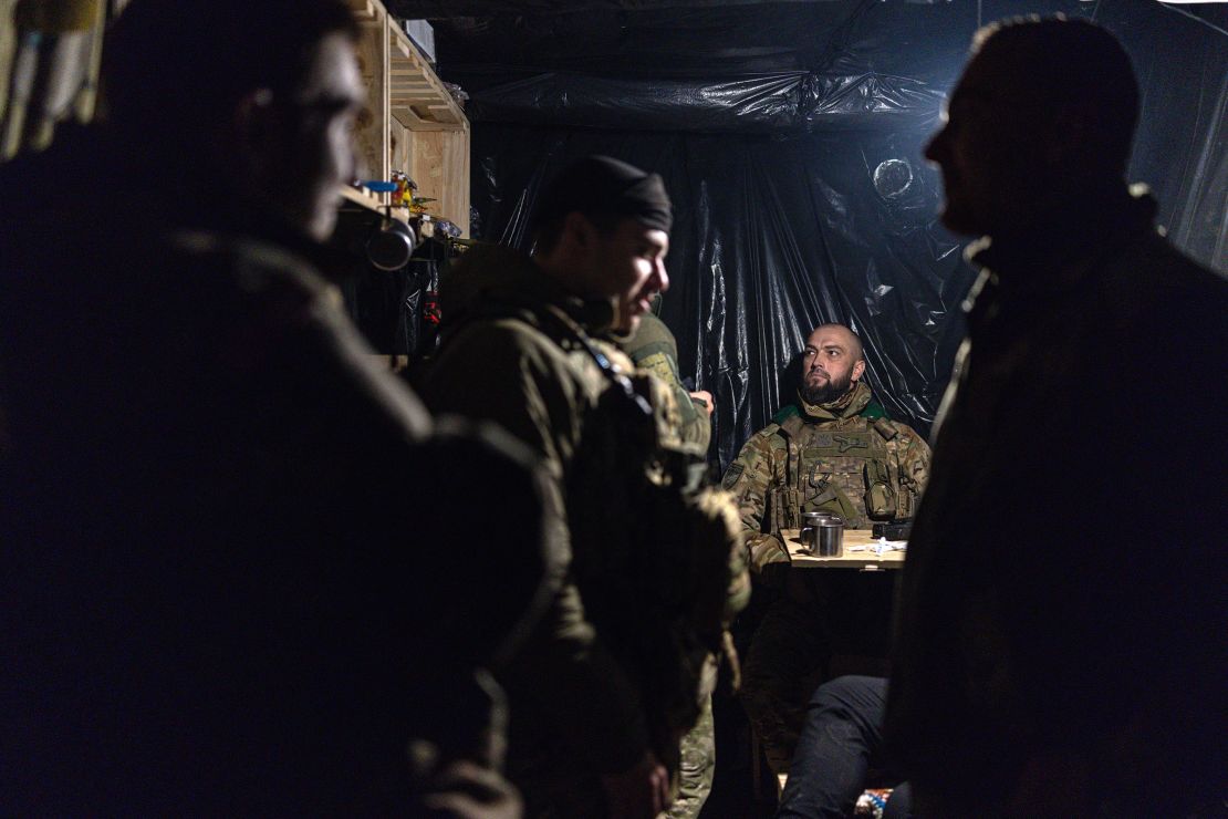 Members of the unit Dnipro One of the Joint Assault Brigade of the National Police of Ukraine "Luty," who operate a Soviet-era howitzer D-30, wait for the command to engage new targets in a dugout on November 9, 2024, near Toretsk, Ukraine. 