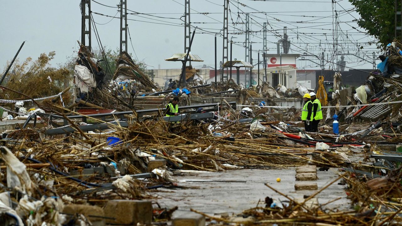 Agents stand amid debris during rain in Paiporta, south of Valencia, eastern Spain, on November 13 in the aftermath of deadly flooding. 