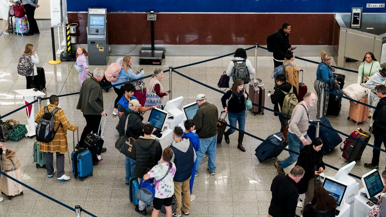 Travelers wait in line at Hartsfield-Jackson Atlanta International Airport (ATL) in Atlanta, Georgia, US, on Wednesday, Nov. 27, 2024.