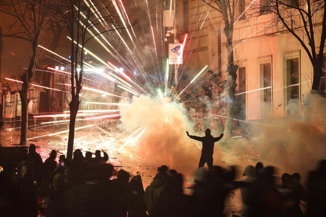 Fireworks explode as protesters clash with police outside Georgia parliament during a demonstration against the government's decision to delay European Union membership talks amid a post-election crisis, in Tbilisi, early on December 1.