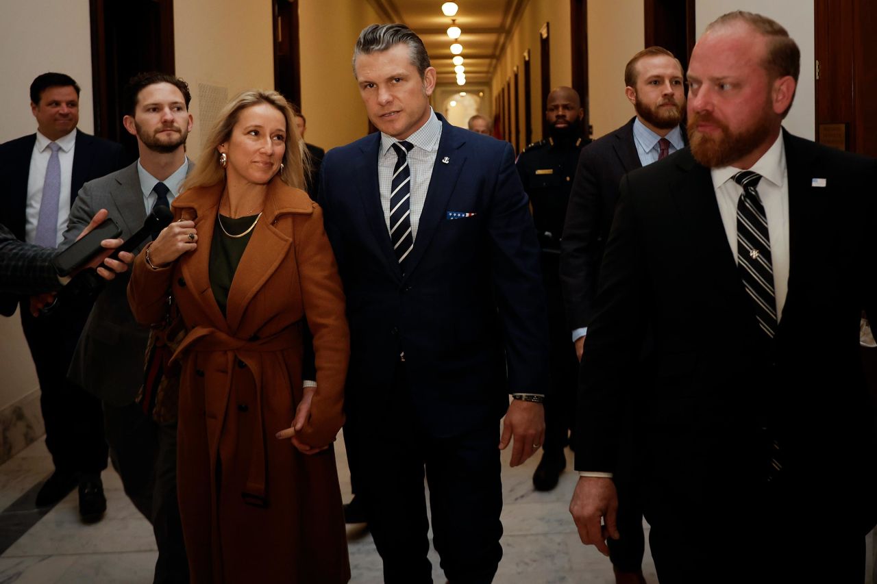 Pete Hegseth, center, and his wife Jennifer Rauchet arrive for meetings in the Russell Senate Office Building on Capitol Hill on December 9, in Washington, DC. 