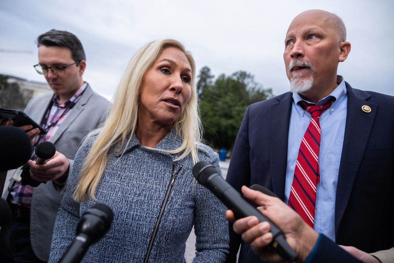 Reps. Marjorie Taylor Greene and Chip Roy talk with reporters outside the US Capitol on Wednesday, December 18.