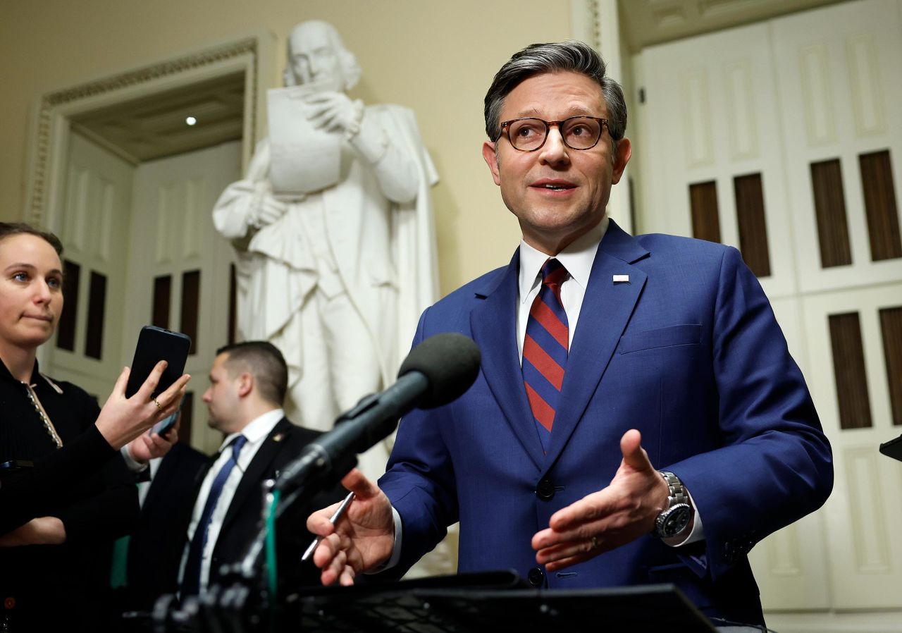 House Speaker Mike Johnson speaks to reporters outside of the House Chambers in the US Capitol on December 19, in Washington, DC.