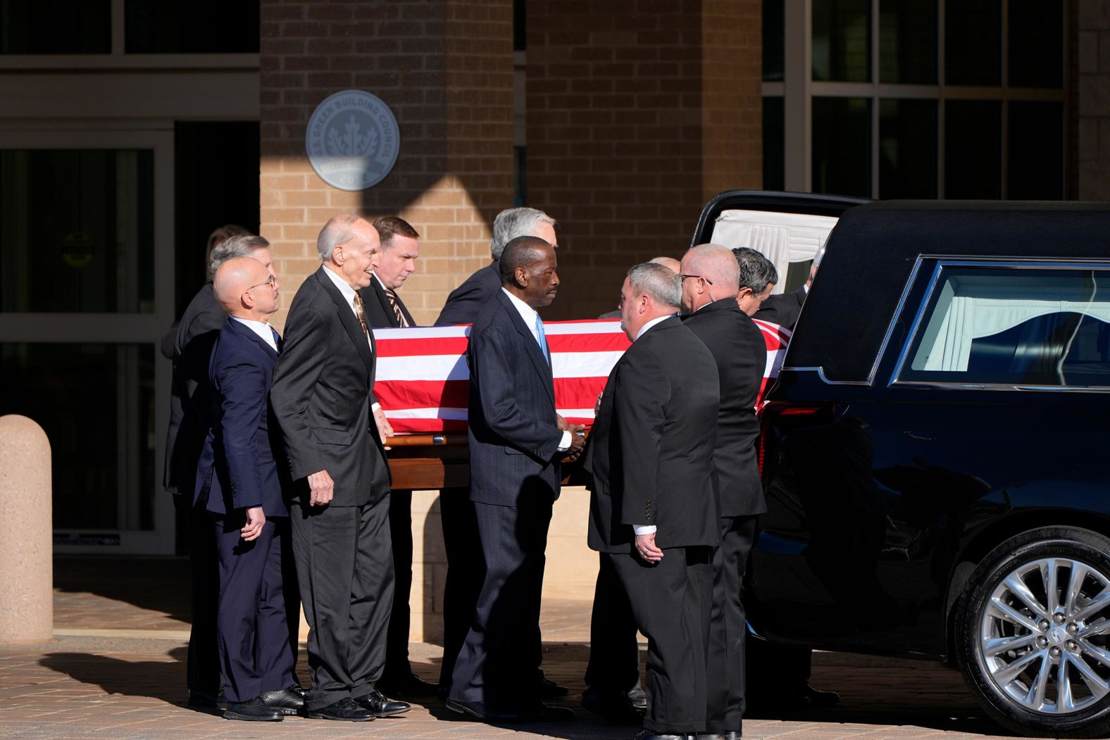 Former and current US Secret Service agents assigned to the Carter detail move the flag-draped casket of former President Jimmy Carter, at Phoebe Sumter Medical Center on January 4, 2025 in Americus, Georgia. 