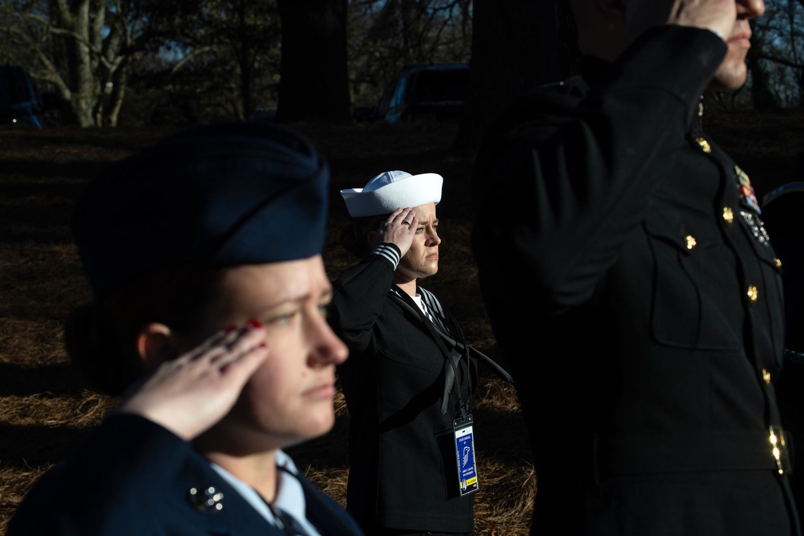 Service members salute as the Carter's casket arrives at the Carter Center on January 4.