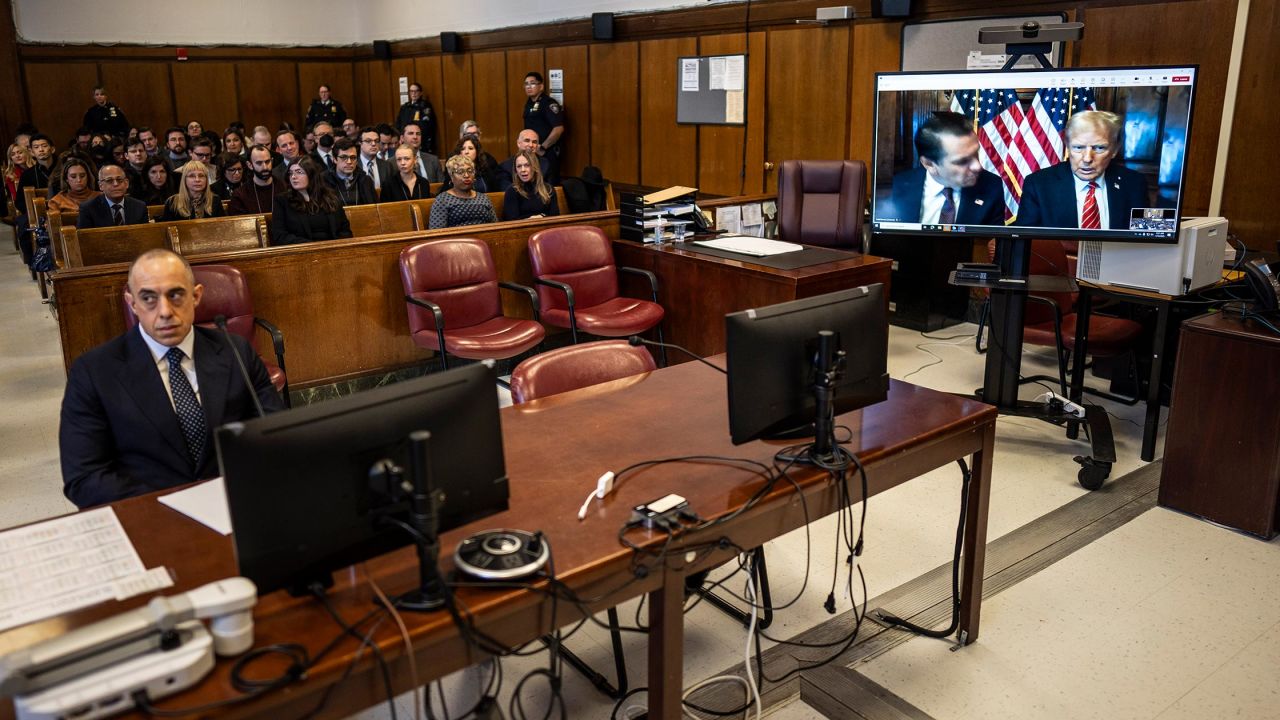 Attorney Emile Beauvais (left) listens as attorney Todd Blanche and President-elect Donald Trump virtually appear for sentencing on a television screen in Manhattan Criminal Court on January 10, 2025 in New York City. 