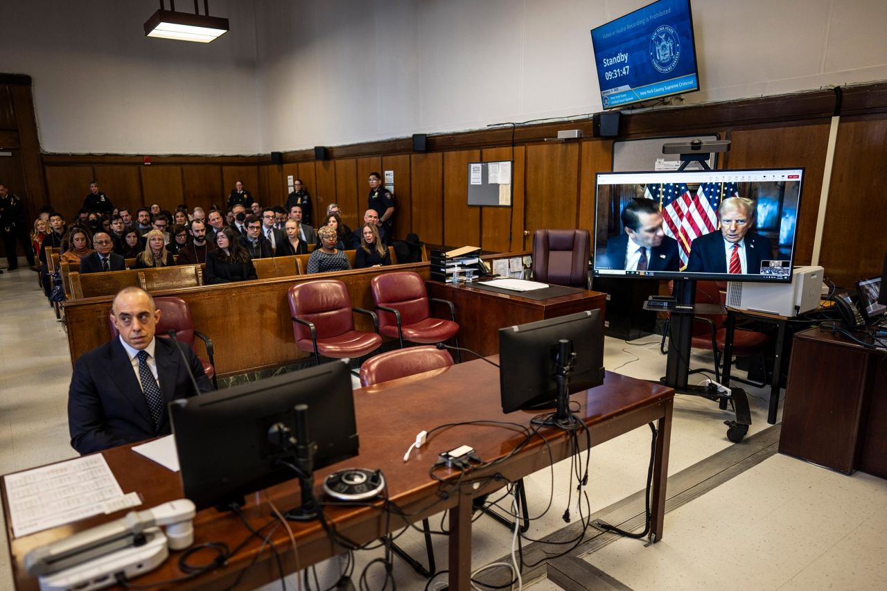 Attorney Emil Bove, left, listens as Attorney Todd Blanche and President-elect Donald Trump, seen on a television screen, appear virtually for sentencing, at Manhattan Criminal Court on January 10, 2025 in New York City. 