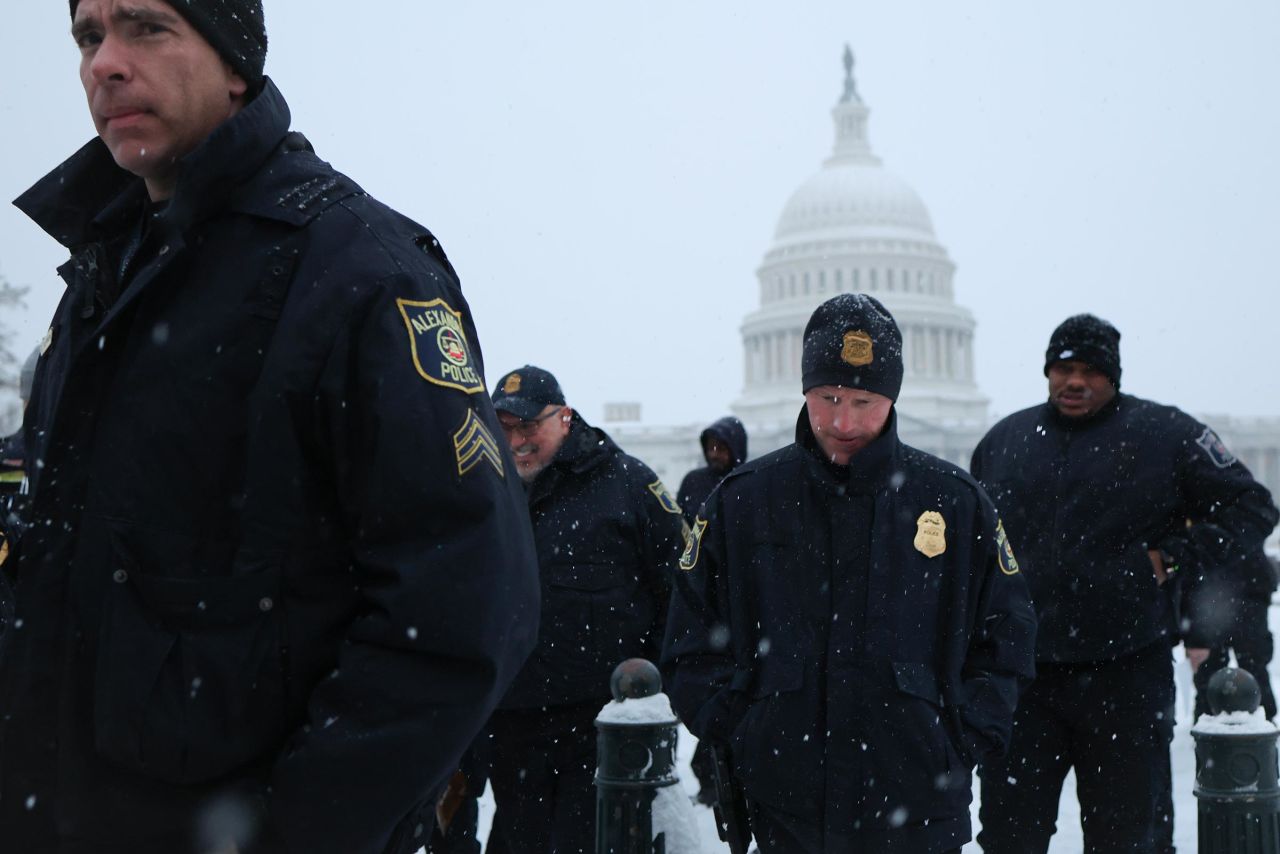 Law enforcement officers patrol outside the US Capitol as snow falls during a winter storm January 6, 2025 in Washington, DC. 