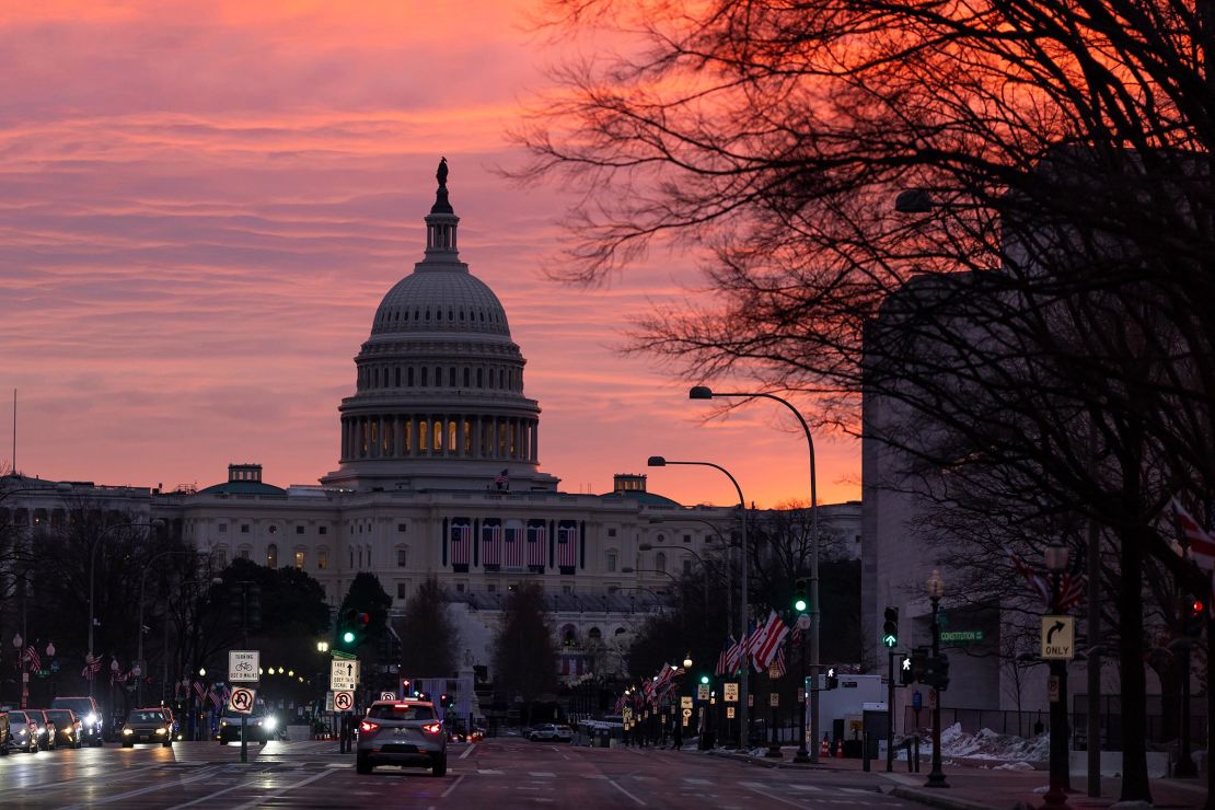 The sun rises behind the US Capitol on January 16, 2025, in Washington, DC. 