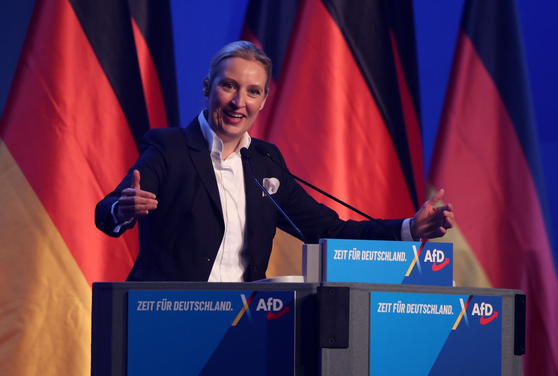 Alice Weidel, chancellor candidate of the far-right Alternative for Germany (AfD) political party, stands next to German flags as she speaks to supporters at the AfD election campaign launch rally on January 25, 2025 in Halle, Germany. 