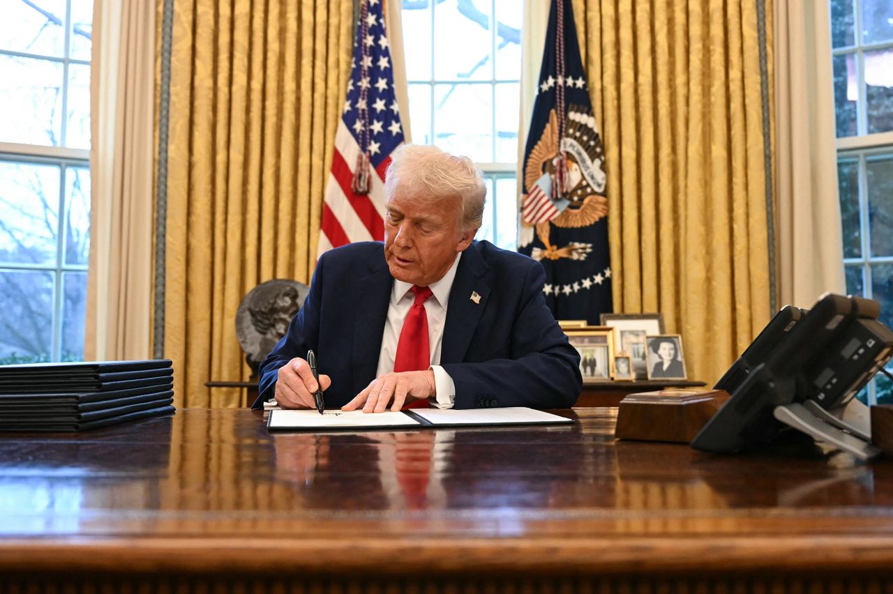 President Donald Trump signs an executive order to create a US sovereign wealth fund in the Oval Office of the White House on February 3, in Washington, DC. 