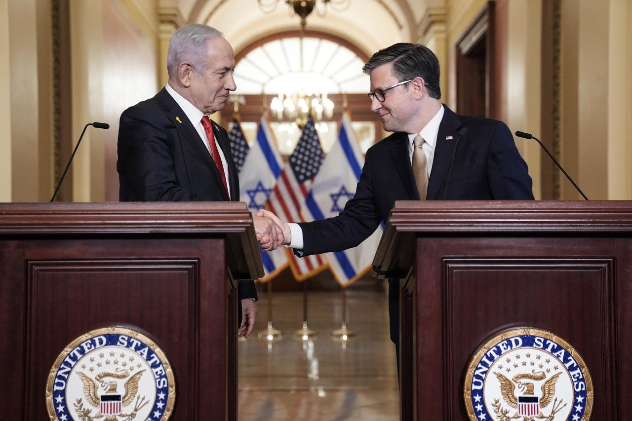 House Speaker Mike Johnson shakes hands with Israeli Prime Minister Benjamin Netanyahu as they speak to the press at the US Capitol following their closed-door meeting in Washington, DC, on February 7.