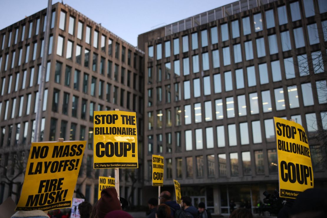 Demonstrators gather outside of the Office of Personnel Management in Washington, DC on February 7, to protest federal layoffs and demand the termination of Elon Musk from the Department of Government Efficiency (DOGE).