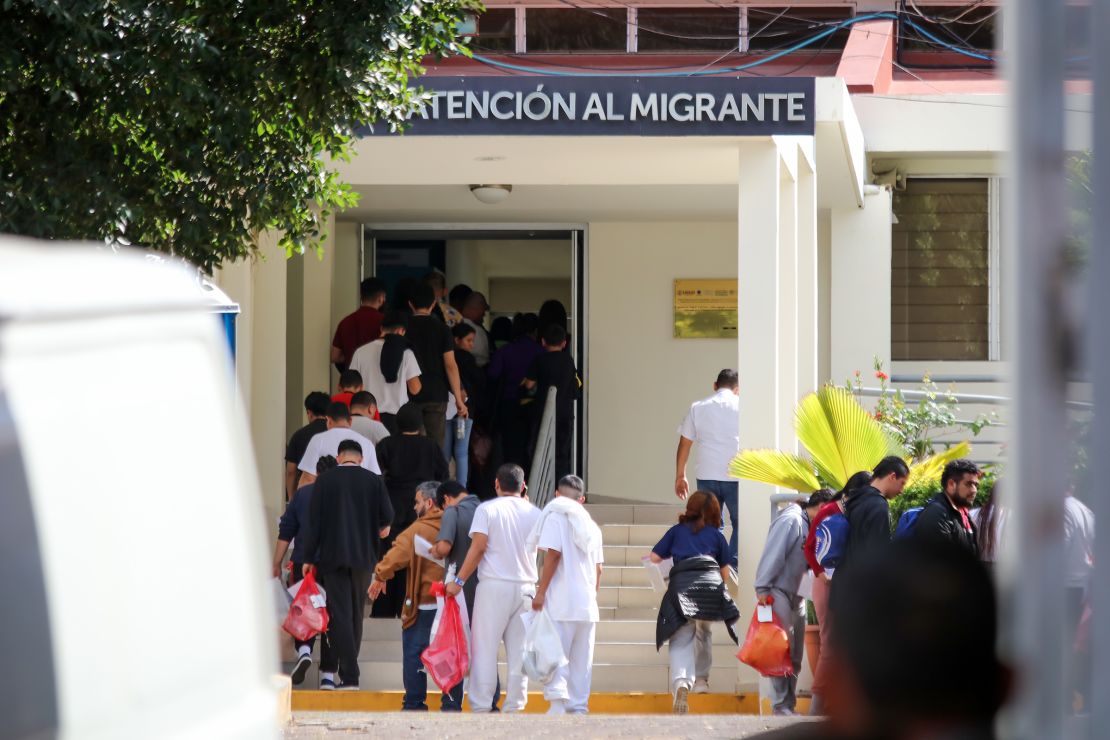 Deported migrants queue to receive an essential items bag during the arrival of a group of deported Salvadorans at Gerencia de Atención al Migrante (GAMI) on February 12, in San Salvador, El Salvador. 