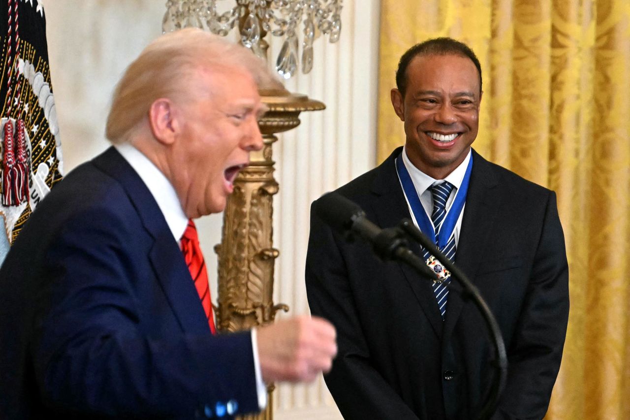 President Donald Trump speaks alongside golfer Tiger Woods during a reception for Black History Month in the East Room of the White House on February 20, in Washington, DC.