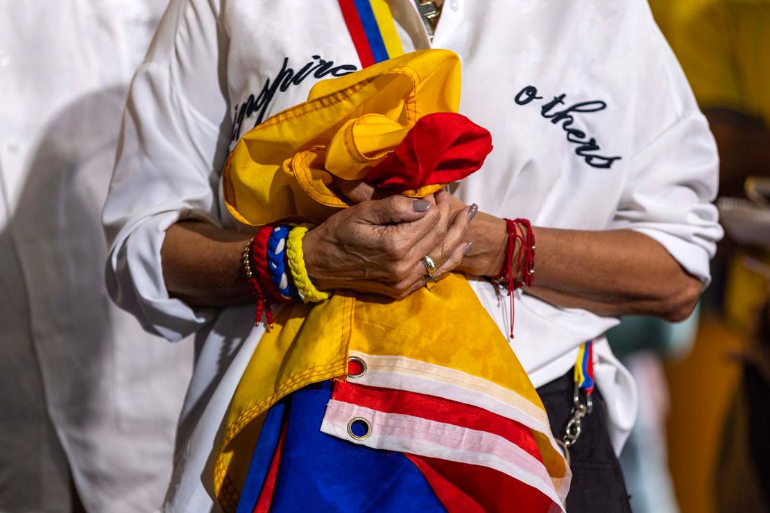 A woman holds a Venezuelan flag during a press conference held by Venezuelan American Caucus and hosted at El Arepazo on February 3 in Doral, Florida. 