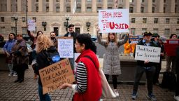 Supporters hold signs as former US Agency for International Development employees on February 27,  in Washington, DC. 