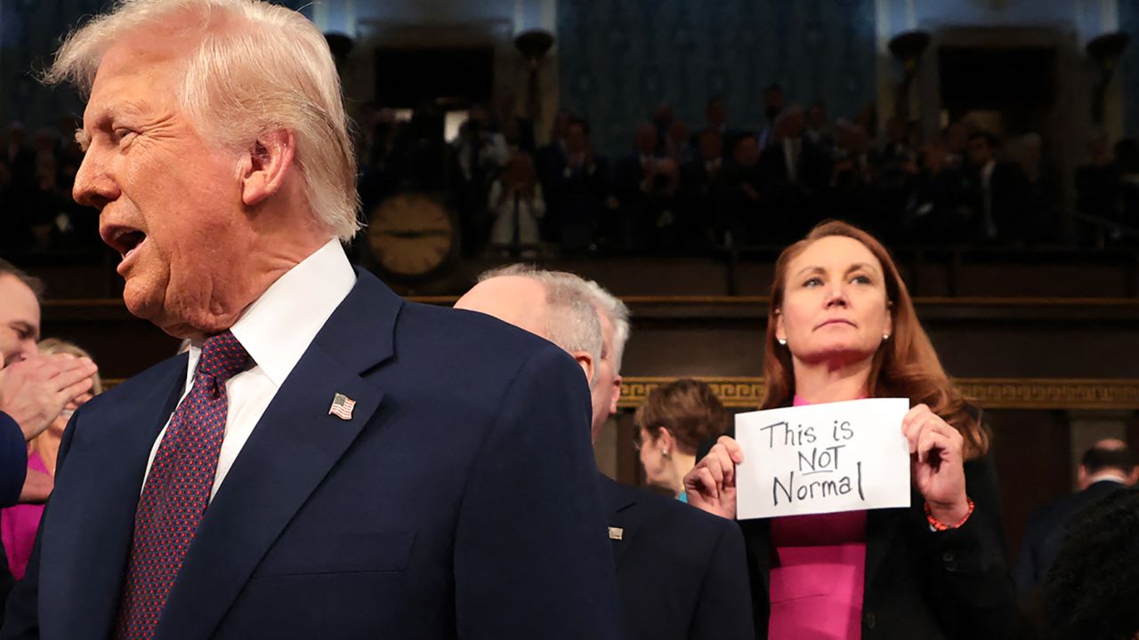 Rep. Melanie Stansbury holds as a sign reading "This is NOT Normal" as Trump enters the House chamber to deliver an address to a joint session of Congress at the US Capitol in Washington, DC, on March 4.