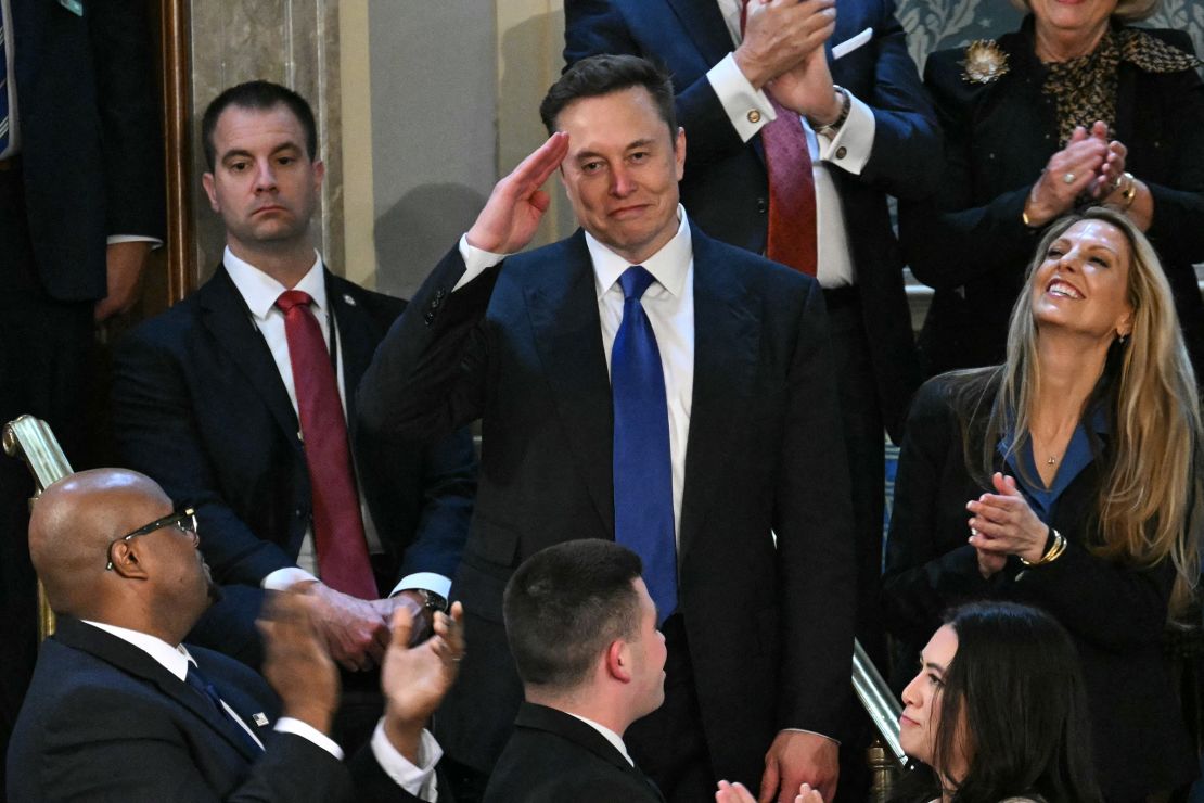 Elon Musk stands as he is recognized by Trump.