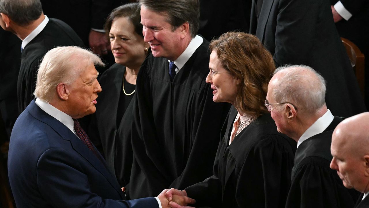 President Donald Trump shakes hands with US Supreme Court Associate Justice Amy Coney Barrett as Trump arrives to address to a joint session of Congress in the House Chamber of the US Capitol in Washington, DC, on March 4.