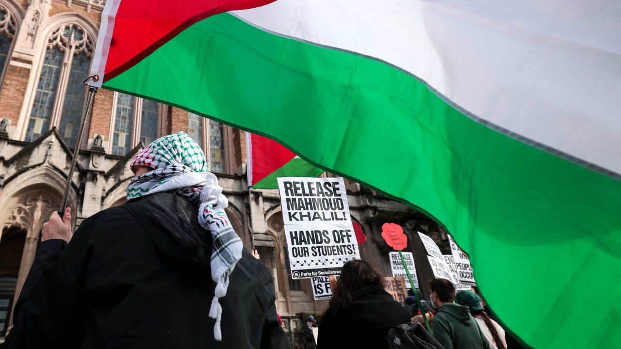 People hold signs and Palestinian flags as they protest the arrest of former Columbia University student activist Mahmoud Khalil in Seattle, Washington, on March 15.