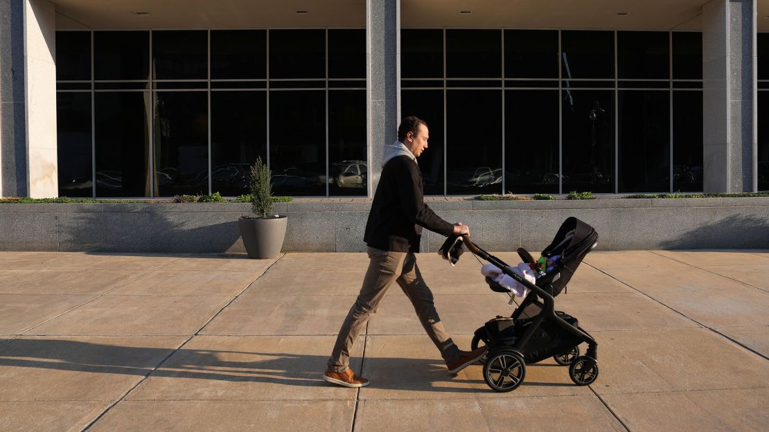 A person pushes a stroller past the Department of Education on March 20, in Washington, DC.