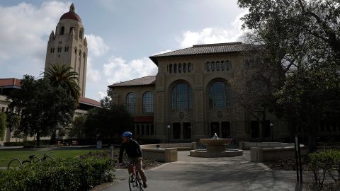 A cyclist rides their bicycle on the Stanford University campus on March 28 in Stanford, California. 