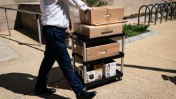A worker wheels out the belongings of a fellow employee who was dismissed, outside of the Mary E. Switzer Federal Office Building, which houses offices for the US Department of Health and Human Services (HHS) in Washington, DC, on Tuesday, April 1. 