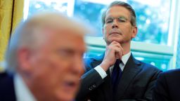 Treasury Secretary Scott Bessent looks on as President Donald Trump signs executive orders in the Oval Office.