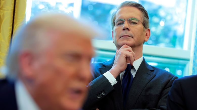 Treasury Secretary Scott Bessent looks on as President Donald Trump signs executive orders in the Oval Office.