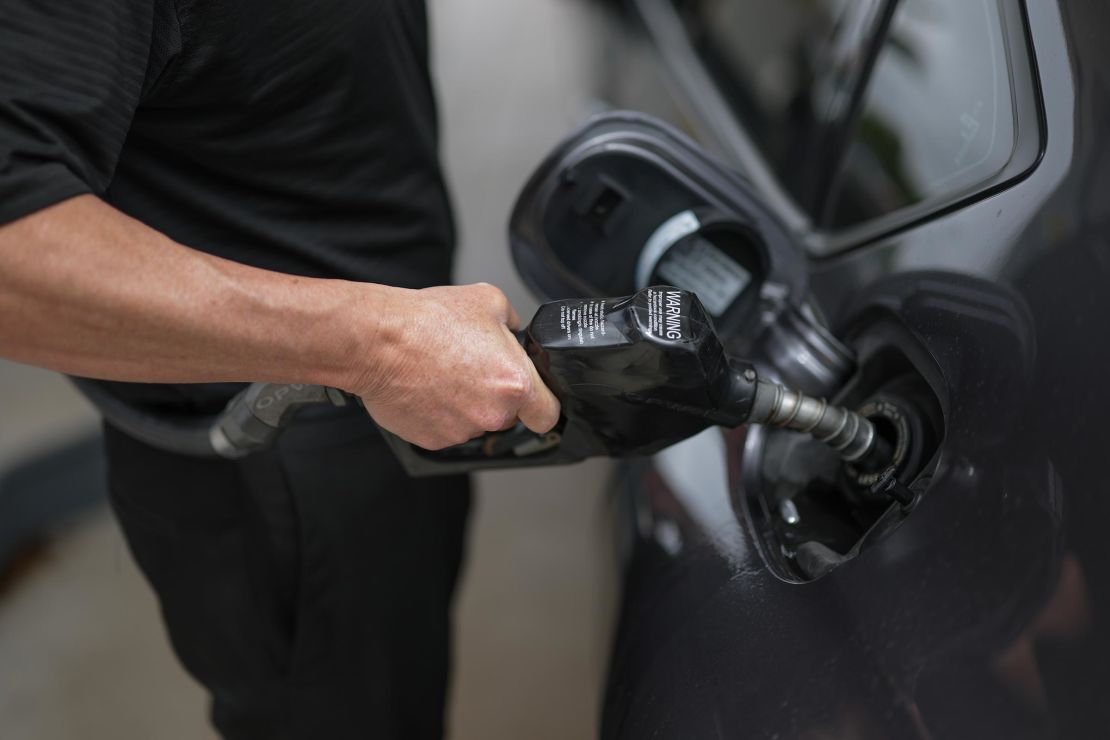 A customer pumps gas into their vehicle at a Shell station on April 10, in Miami.