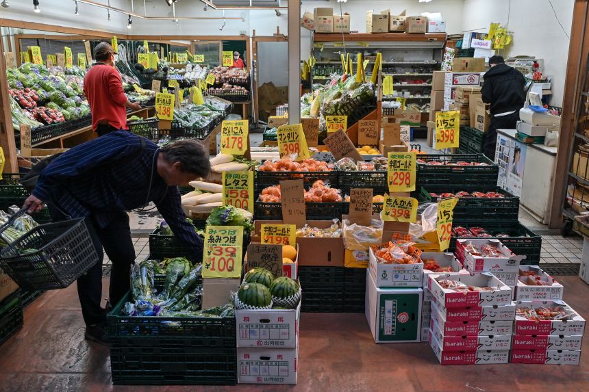 People shop for fruit and vegetables at a fresh produce market in the Minowa area of Tokyo on April 15.