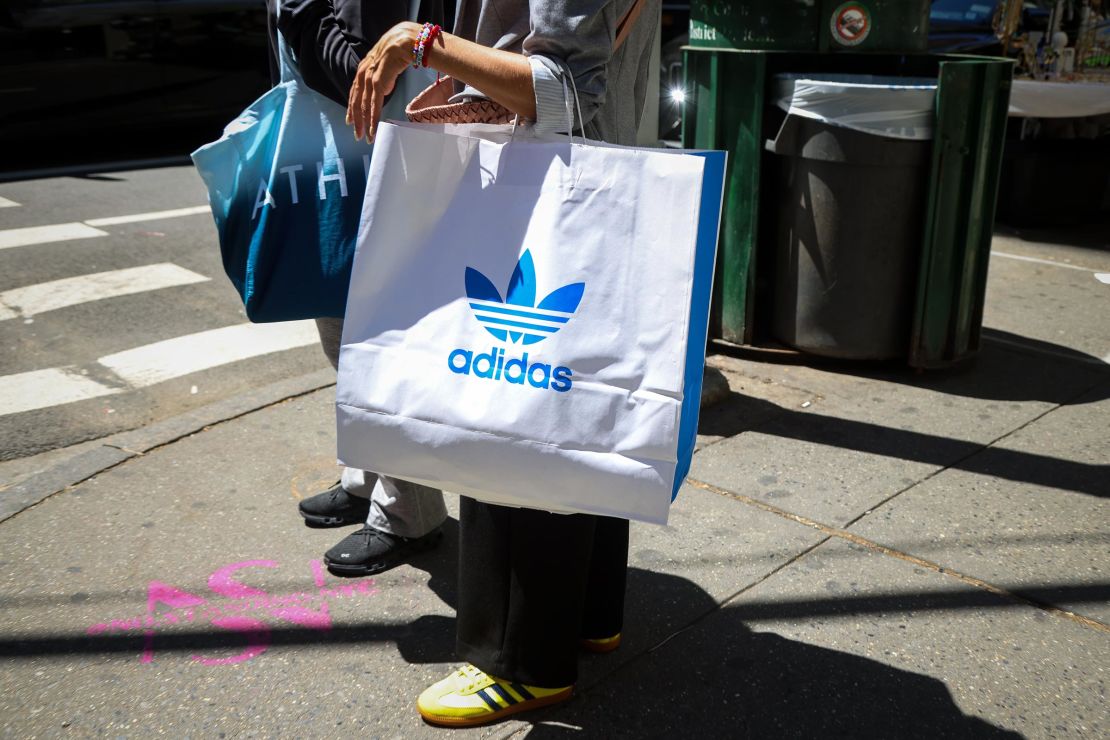 A shopper carries an Adidas bag in New York, on Wednesday, April 30.