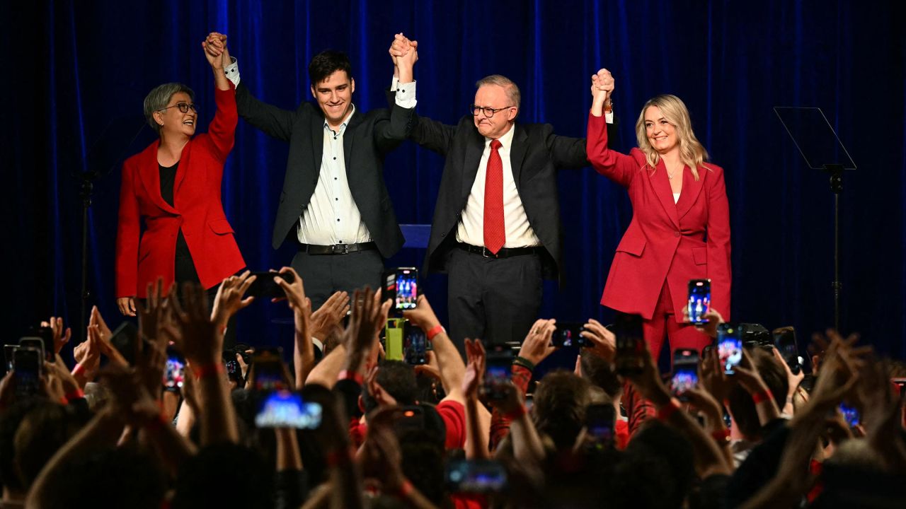Australia's Prime Minister Anthony Albanese celebrates with his partner Jodie Haydon, son Nathan Albanese and Australia's Foreign Minister Penny Wong after winning the general election at the Labor Party election night event in Sydney on May 3.