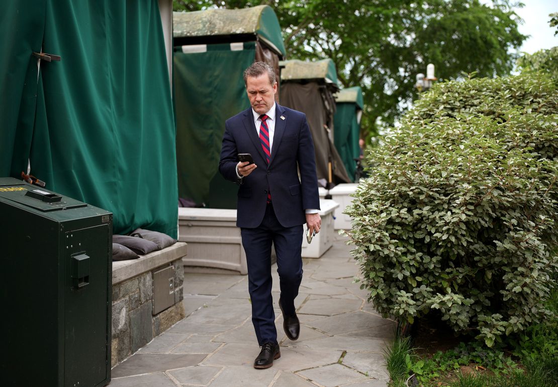 National Security Advisor Michael Waltz looks at his phone as he prepares for a TV interview at the White House on May 1, in Washington, DC.