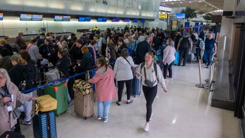 People wait in line for a delayed flight at Newark International Airport on May 5 in Newark, New Jersey.