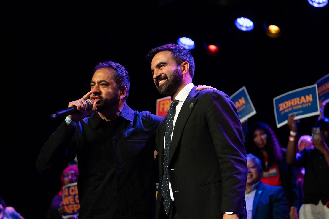Actor Kal Penn and Zohran Mamdani stand side by side while addressing the crowd at a rally at Brooklyn Steel in Brooklyn New York on May 4.