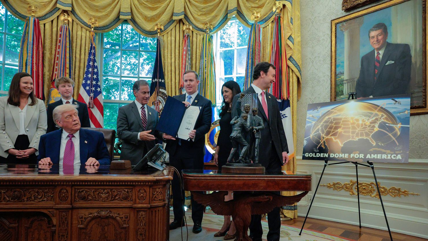 President Donald Trump is joined by Republican lawmakers Sen. Ashley Moody, her son Connor, Rep. Gary Palmer, Rep. Brian Jack, Rep. Stephanie Bice and Rep. Craig Goldman as Trump signed Congressional resolutions into law in the Oval Office at the White House on May 9, in Washington, DC.
